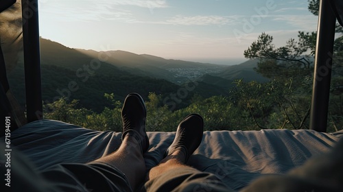 Person lying on the bed looking at the ti, view of the feet touching each other with black socksAerial Drone view of coastal road in Tuscany, Italy 