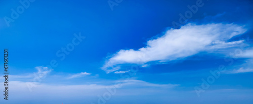 Panoramic view of sunlight blue sky with alone fluffy cloud, amazing sky background. Panorama of cloudscape, atmospheric backdrop, cozy wallpaper. Design style backgrounds concept. Copy ad text space