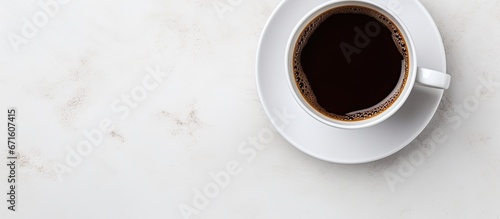 Flat lay design element of isolated white coffee cup with hot black coffee seen from above