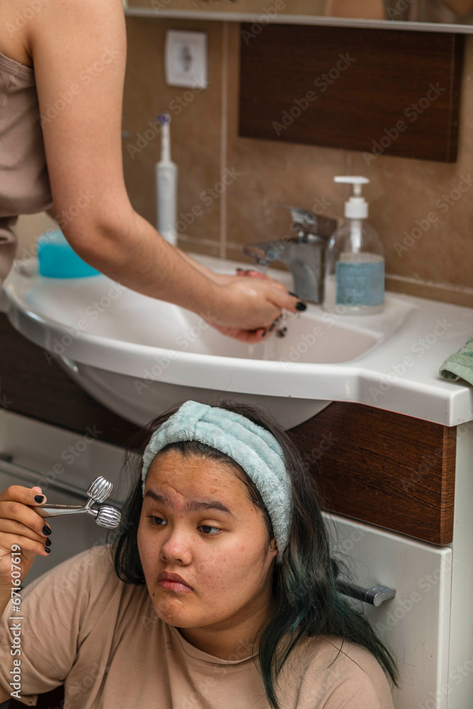 Asian beauty start their morning routine with washing and face massage in the bathroom Asian beauty start their morning routine with washing and face massage in the bathroom
