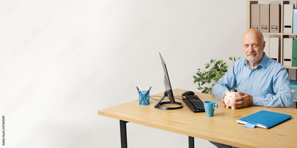 Businessman holding a piggy bank: financial services Businessman holding a piggy bank: financial services