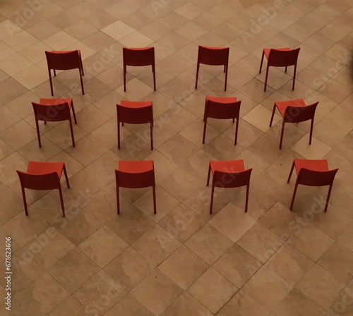 Red chairs are arranged for people who are interested in watching the performances in the multipurpose area.