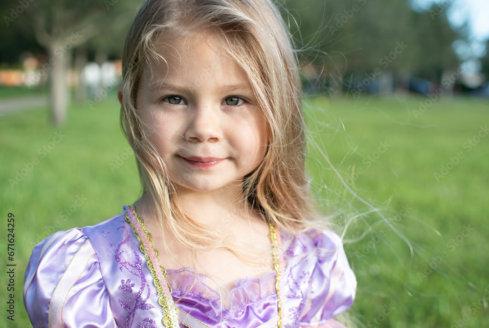 Portrait of a beautiful smiling little girl with a long blond hair. Happy child outdoors Portrait of a beautiful smiling little girl with a long blond hair. Happy child outdoors