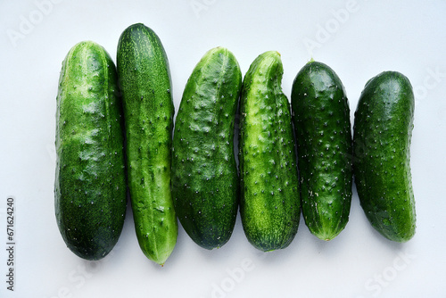 Green ripe cucumbers on a white background. Delicious and juicy green vegetables.