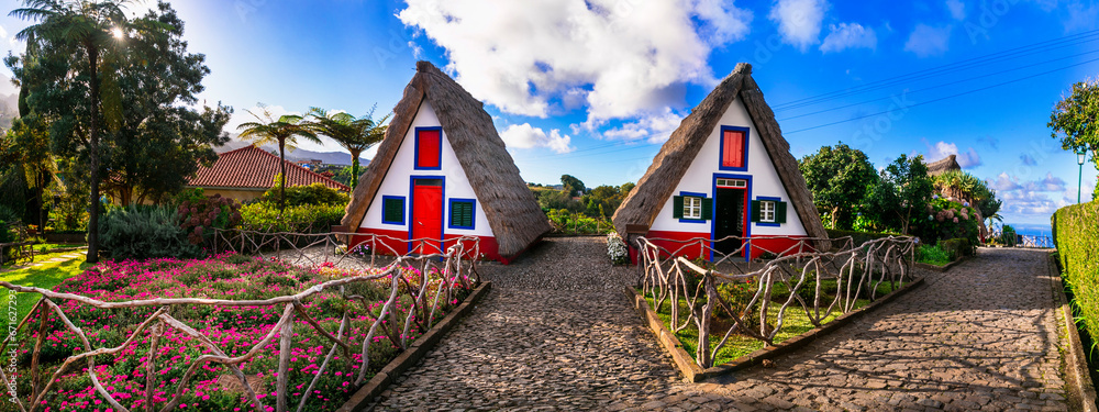 Madeira island travel and landmarks. Folk Museum in Santana town. Charming traditional colorful houses with thatched roofs, popular tourist attraction in Portugal - obrazy, fototapety, plakaty 