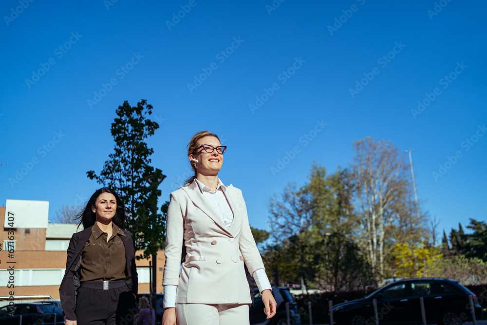 two proud and smiling businesswomen walked towards success, women empowerment concept two proud and smiling businesswomen walked towards success, women empowerment concept