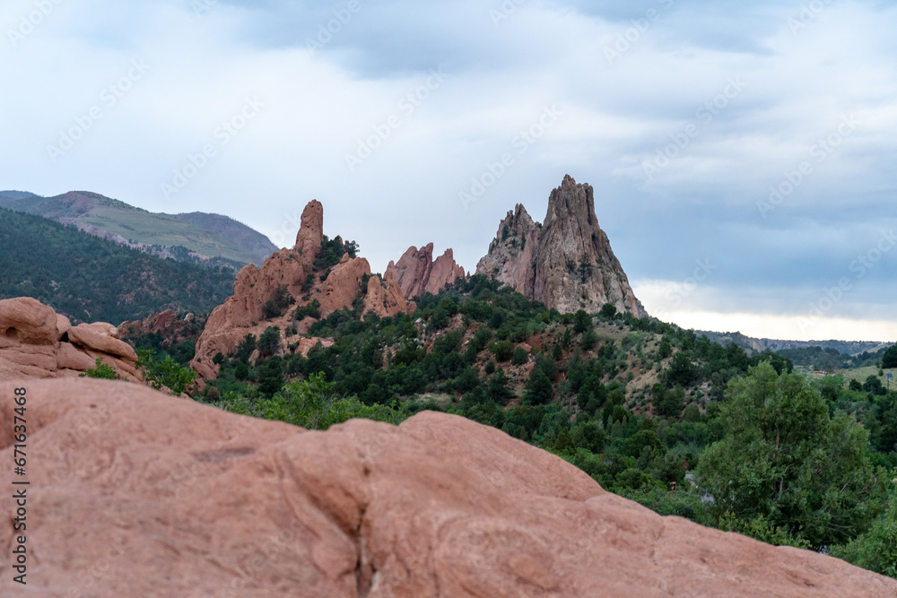 A view of rock formations in Garden of the Gods around sunset, in Colorado Springs, CO on a cloudy summer evening 