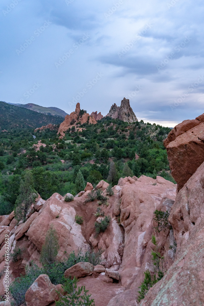 A view of rock formations in Garden of the Gods around sunset, in Colorado Springs, CO on a cloudy summer evening 