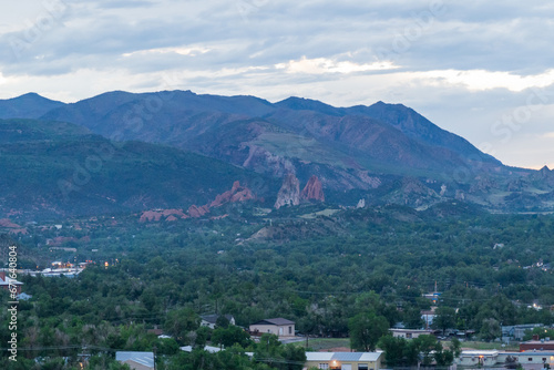 A view of Garden of the Gods from afar at sunset on a cloudy evening in Colorado Springs, CO