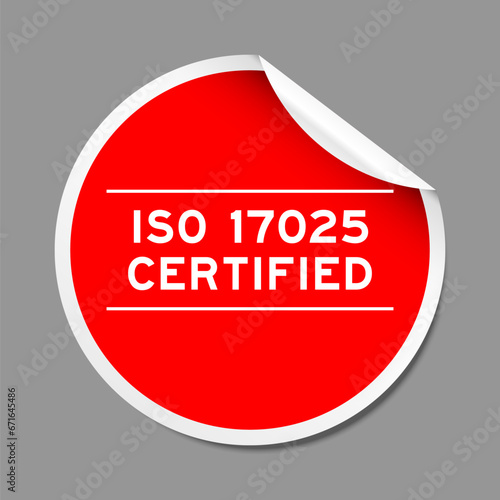 Red color peel sticker label with word ISO 17025 on gray background