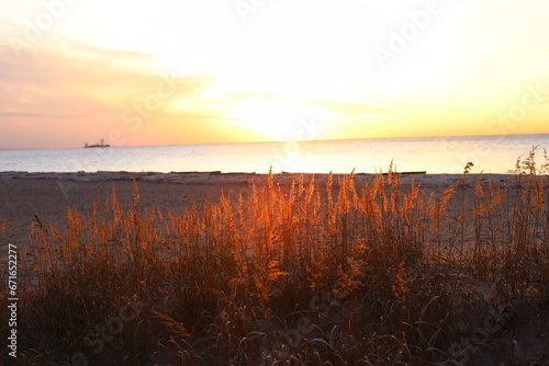 Autumn Sunset on the seashore. Reflection of the sun s rays in the sea waves.