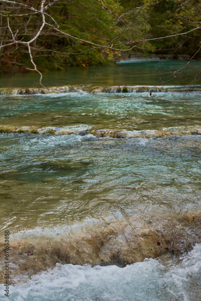 The waterfalls and crystal clear, blue, turquoise and green waters of the Nacedero del Urederra, with its beech forest with its autumn colors in the Sierra de Urbasa-Andía. Navarre. Spain