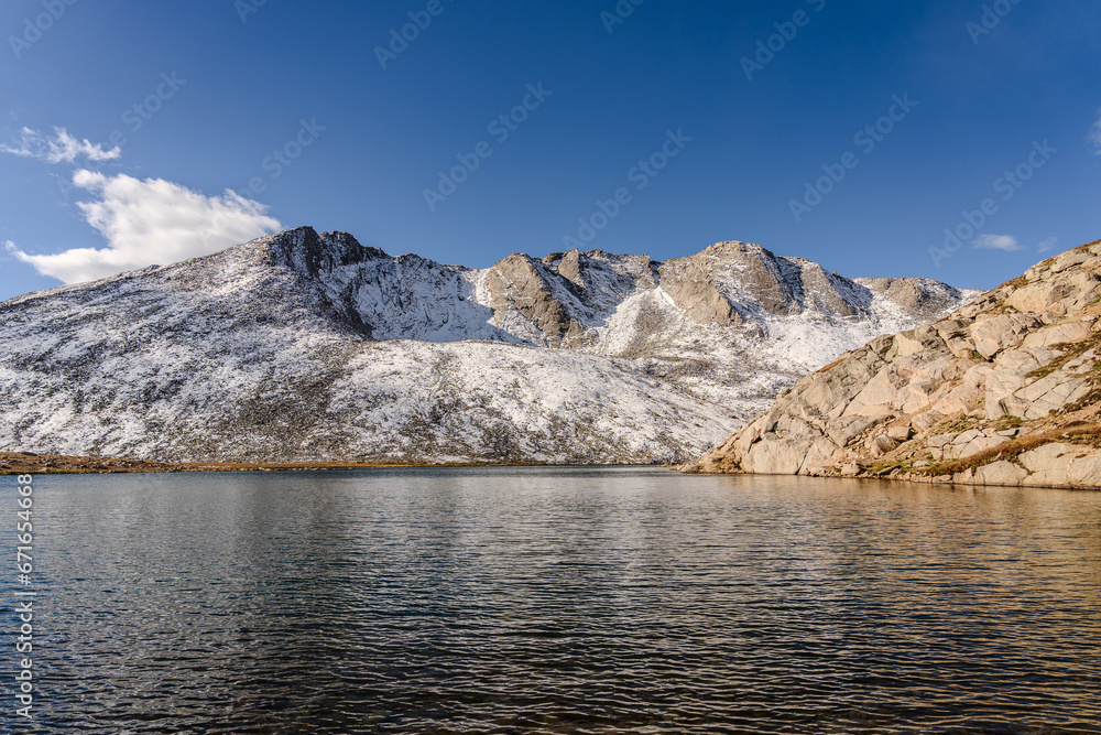 Snow covered mountain, water, and tundra at Summit Lake at Mount Evans/Mount Blue Sky near Idaho Springs, Colorado, on a sunny fall/winter day
