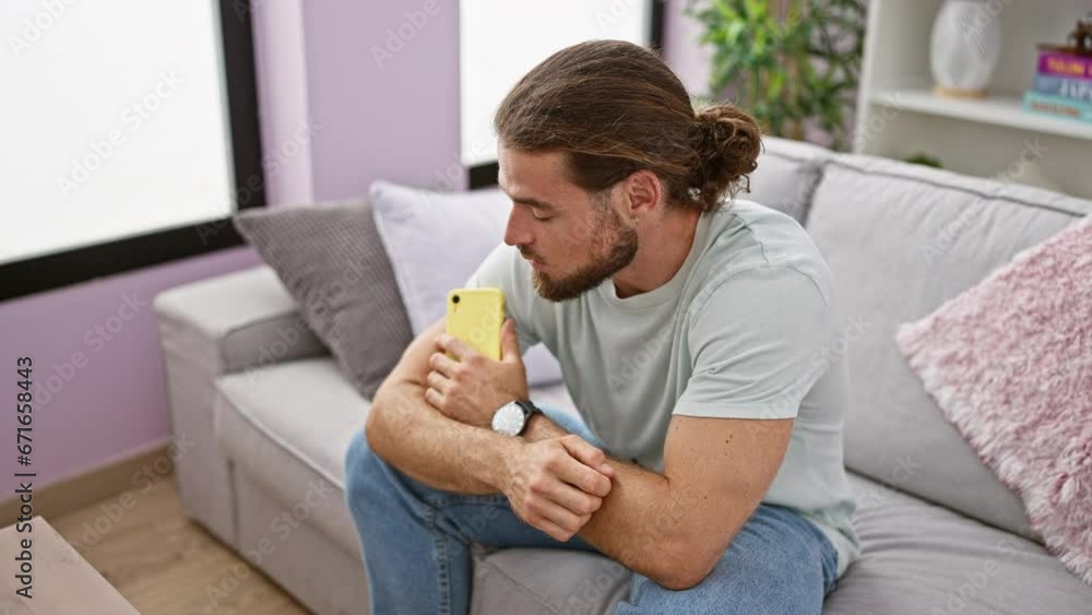 Young hispanic man using smartphone sitting on sofa thinking at home Young hispanic man using smartphone sitting on sofa thinking at home
