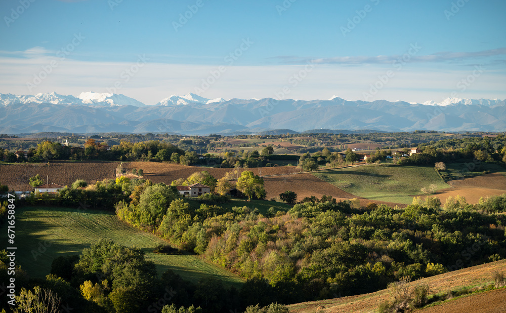 Naklejka premium Countryside landscape in the Gers department in France with the Pyrenees mountains in the background 