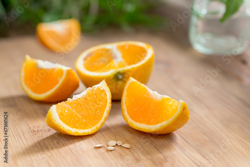 Freshly sliced organic orange on a wooden table