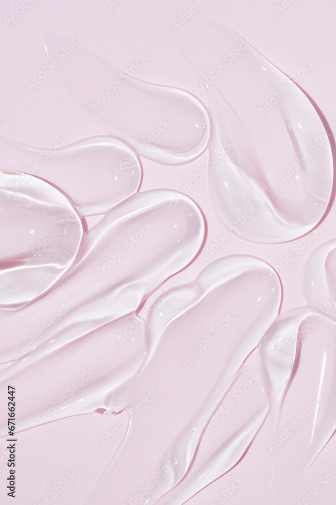 Liquid gel cosmetic smudge drops texture on bpink background. cosmetic smears cream texture. skin care product stroke flat lay, cream with hyaluronic acid Liquid gel cosmetic smudge drops texture on bpink background. cosmetic smears cream texture. skin care product stroke flat lay, cream with hyaluronic acid
