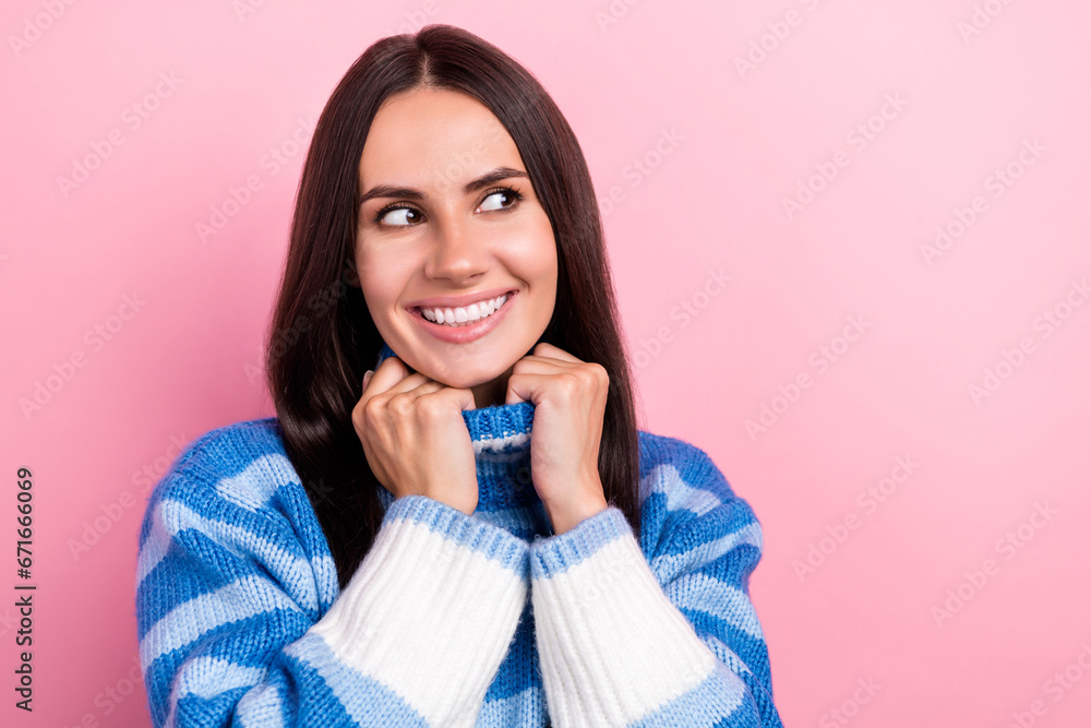 Portrait of gorgeous positive girl toothy smile hands touch sweater collar look empty space isolated on pink color background Portrait of gorgeous positive girl toothy smile hands touch sweater collar look empty space isolated on pink color background