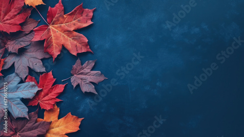 Autumn background with colored maple leafs on blue slate background, Top view.