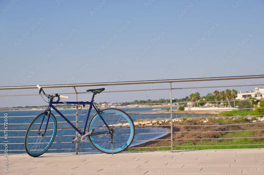 Sporty bike leaning on a railing, blue sea in the background