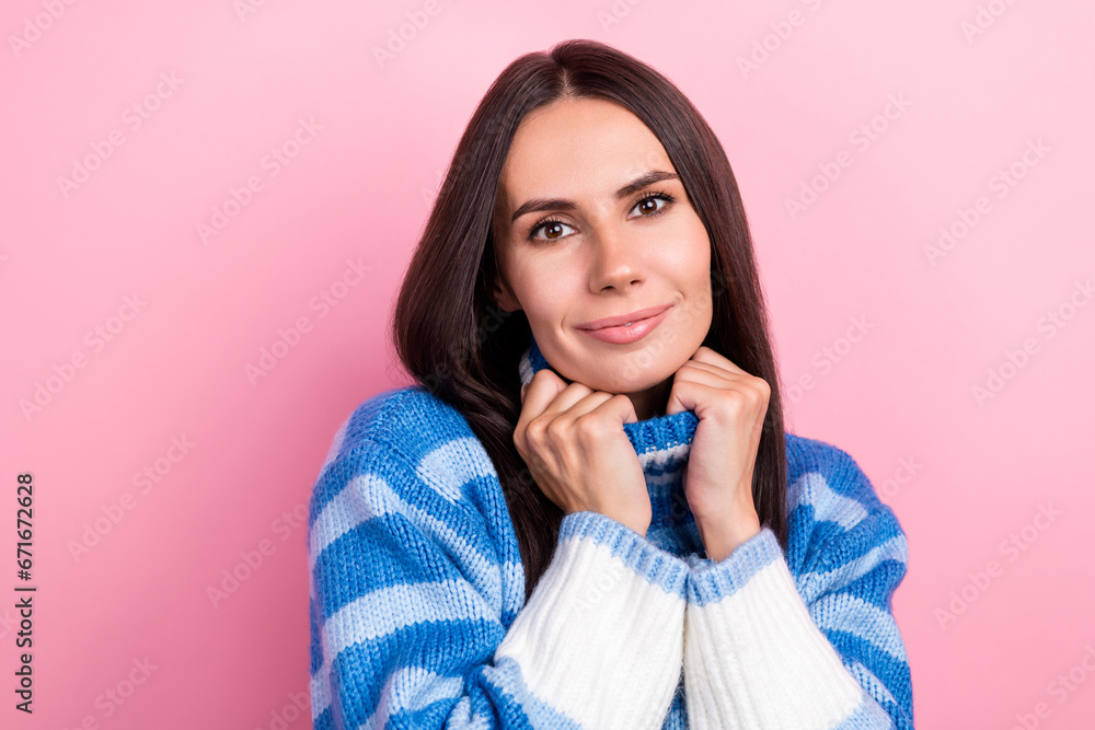 Photo of lovely peaceful positive lady hands touch warm pullover collar isolated on pastel pink color background Photo of lovely peaceful positive lady hands touch warm pullover collar isolated on pastel pink color background