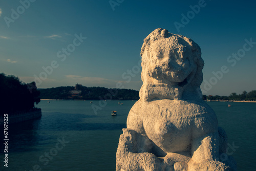 Summer Palace in Beijing.  Imperial garden in the Qing dynasty. Chinese ancient buildings. Jin dynasty. Old lion statue. Around Longevity Hill and Kunming Lake. Seventeen-Arch Bridge Shiqikong Qiao  photo