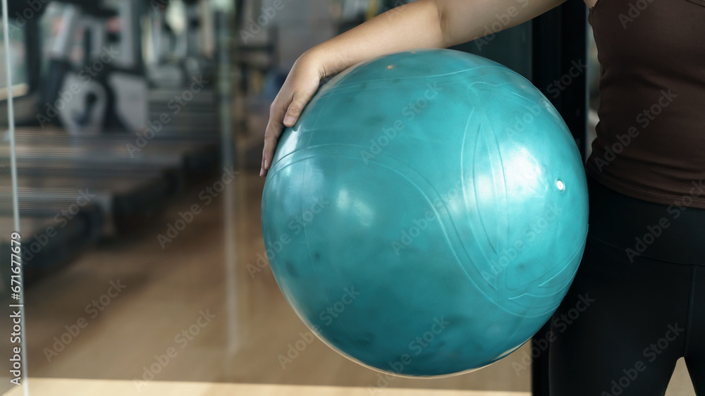 Sporty woman exercising hold ball fitness workout and health concept. training working out Sporty woman exercising hold ball fitness workout and health concept. training working out