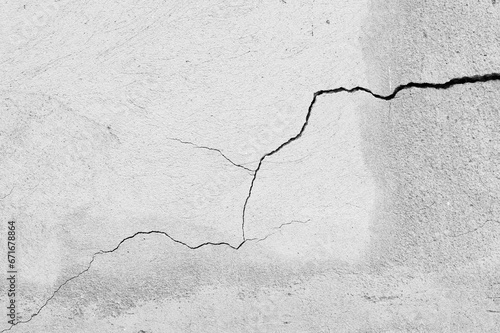 An old wall with a cracked texture is decorated with cement mortar