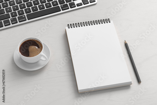 Notebook mockup. Blank workplace notebook. Spiral notepad on white wooden desk