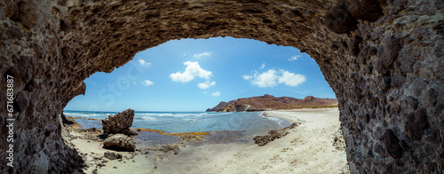 Panoramic photography. Cala de la Media Luna - Cabo de Gata Natural Park, is a cove with fine sand and a quiet environment. People alternate with or without swimsuits, each at their own free choice.  photo