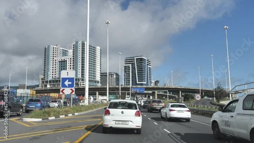 Cape Town, South Africa - September 22, 2023: Slow traffic proceeding toward city, past gore sign 1