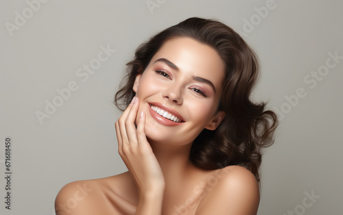 Beautiful smiling woman touching face with hand
