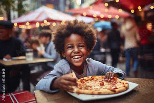 Cheerful African American boy eating pizza at street food