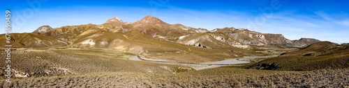 Traveling the famous Ruta40 in the scenic Argentinian highlands - fantastic views while driving through colorful and remarkably shaped mountains and watching wildlife in high altitude in South America photo