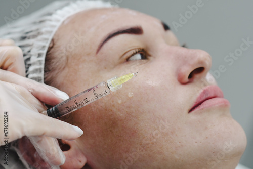 Injection cosmetology. cosmetologist gives an injection to the face. beauty injections