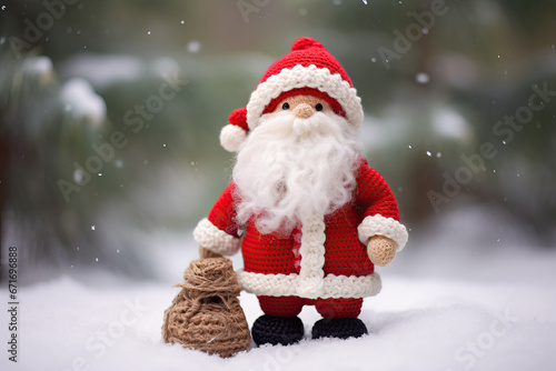 crocheted cute Santa Claus standing in the snow © wernerimages