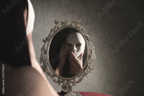 woman in front of the mirror takes off her mask, abstract concept
