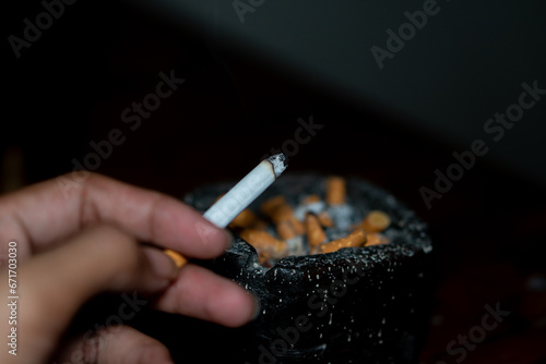 cigarette in astray on black background photo