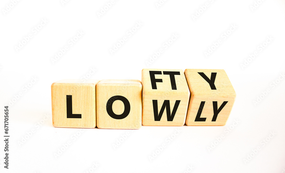 Lofty or lowly symbol. Concept words Lofty Lowly on wooden block. Beautiful white table white background. Business lofty or lowly concept. Copy space. Lofty or lowly symbol. Concept words Lofty Lowly on wooden block. Beautiful white table white background. Business lofty or lowly concept. Copy space.