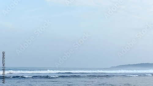 beautiful blue waves crashing along the shoreline. view in the afternoon off the ocean coast