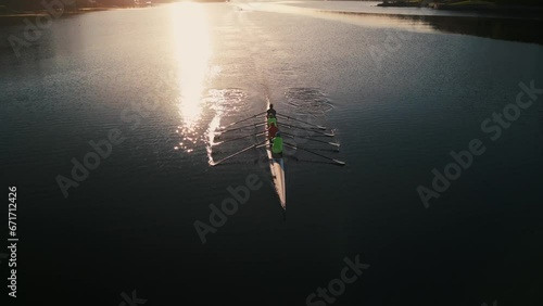 Aerial view of a crew of athletes rowing a boat at sunrise. Halifax, Canada photo
