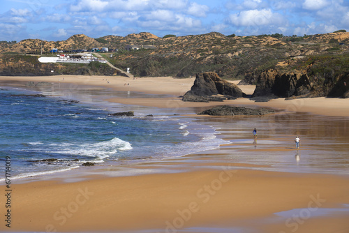 Beautiful Almograve beach with black basalt rocks in Portugal photo