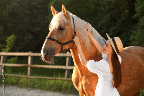 Woman with adorable horse outdoors. Lovely domesticated pet