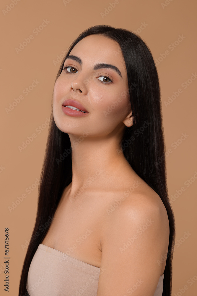 Beautiful woman with long hair on beige background Beautiful woman with long hair on beige background