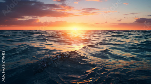 The glistening and peaceful ocean, with the sun setting in the background