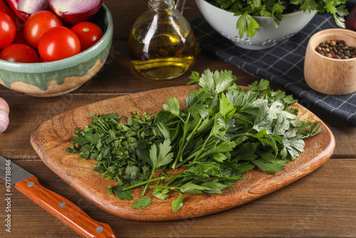 Fresh green parsley and different products on wooden table