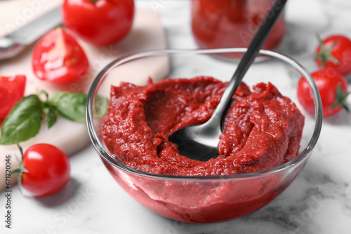 Wallpaper Mural Glass bowl of tasty tomato paste with spoon and ingredients on white marble table, closeup Torontodigital.ca