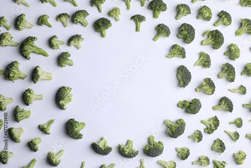 Frame made of many fresh green broccoli pieces on white background, flat lay. Space for text