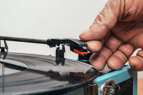 Photography Extreme close up horizontal photo, senior adult, preparing vinyl on turntable