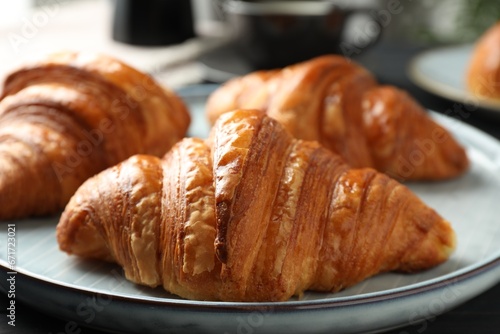 Delicious fresh croissants on dark table  closeup